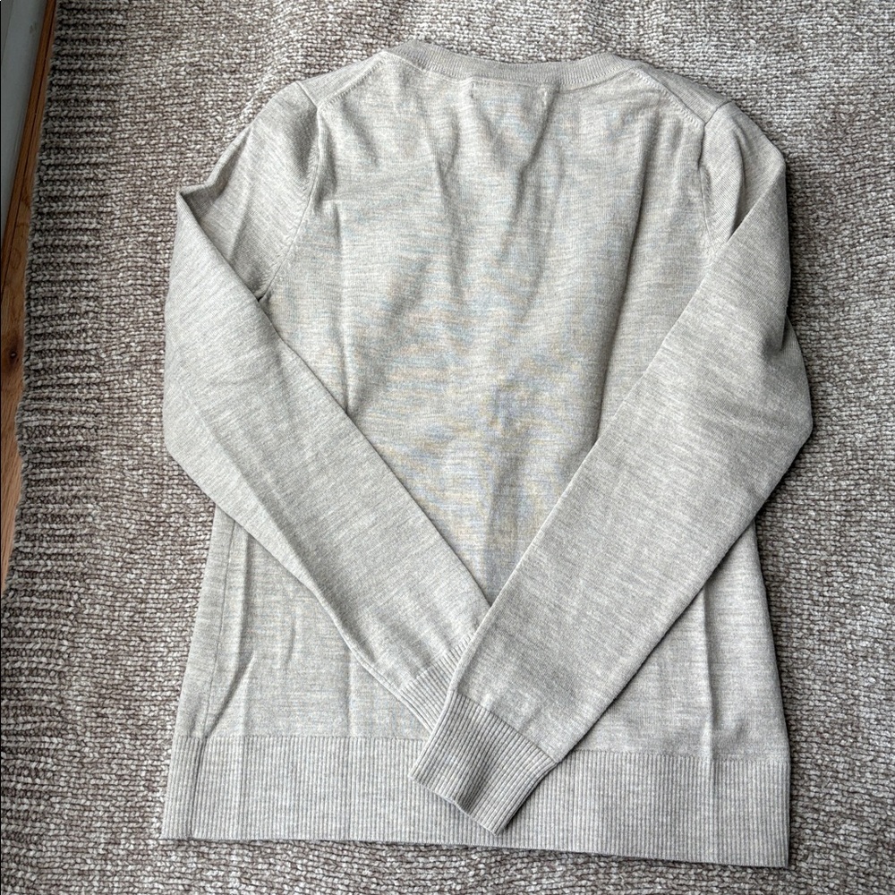 Tan cardigan wool blend sweater. Buttons are sewn on a cute velvet ribbon.